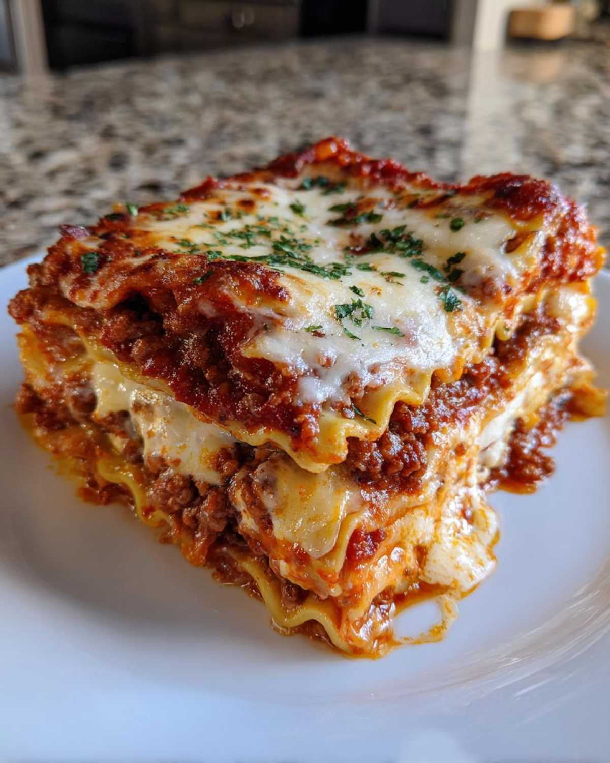 A thick, layered slice of homemade lasagna featuring rich meat sauce, creamy cheese, and fresh parsley garnish.