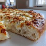 Cross-section view showing the airy interior and melted cheese topping of the amazing 15-Minute white pizza.
