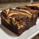 Close-up of a fudgy peanut butter swirl brownies square showing the rich chocolate base and creamy peanut butter topping.