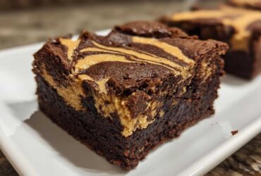 Close-up of a fudgy peanut butter swirl brownies square showing the rich chocolate base and creamy peanut butter topping.