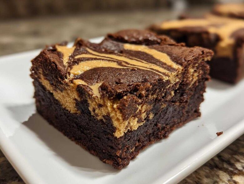 Close-up of a fudgy peanut butter swirl brownies square showing the rich chocolate base and creamy peanut butter topping.