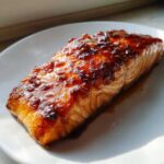 Close-up of a perfectly cooked, glazed piece of salmon from the baked salmon recipe.