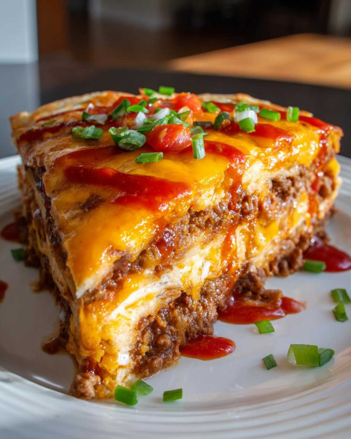 A thick, layered slice of Mexican pizza copycat, topped with melted cheese, salsa, and green onions.