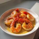 Close-up of plump shrimp coated in creamy garlic butter sauce, prepared using the Instant Pot Creamy Garlic Butter Shrimp Scampi recipe.