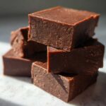 A close-up stack of rich, dark No-Bake Espresso Chocolate Fudge Squares resting on a light surface.