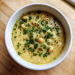 Close-up of a bowl of Vegan Creamy Lemon Garlic White Bean Soup topped with fresh parsley.