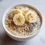 Close-up of Banana Cream Pie Blended Chia pudding topped with banana slices, chia seeds, and graham cracker crumbs.