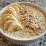 Close-up of Banana Cream Pie Blended Chia pudding topped with sliced bananas and graham cracker crumbs.