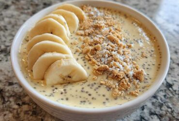 Close-up of Banana Cream Pie Blended Chia pudding topped with sliced bananas and graham cracker crumbs.