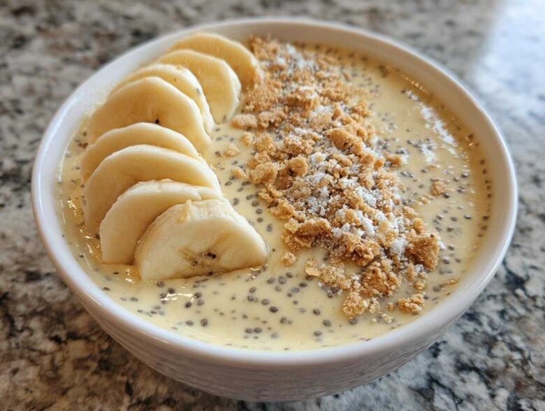 Close-up of Banana Cream Pie Blended Chia pudding topped with sliced bananas and graham cracker crumbs.