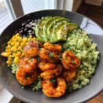 A vibrant Chipotle Lime Shrimp Bowl featuring seasoned shrimp, cilantro-lime rice, corn, black beans, and sliced avocado.