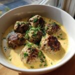 Six browned Greek meatballs served in a creamy, yellow lemon sauce and topped generously with fresh dill.