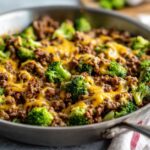 Close-up of a Keto Hamburger Broccoli Skillet with melted cheddar cheese over ground beef and bright green broccoli florets.