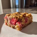 A single square of moist Strawberry Blondies One Bowl recipe featuring visible chunks of bright red strawberries.