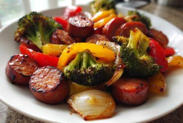 Close-up of glazed Honey Garlic Kielbasa & Veggies, featuring seared sausage, broccoli, and colorful bell peppers.