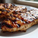 Close-up of juicy Grilled Honey Mustard Chicken Breasts with visible grill marks and a shiny glaze.