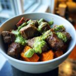 Close-up of Steak and Sweet Potato Bowls topped with vibrant green avocado-cilantro drizzle.